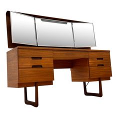 a wooden desk with two drawers and a large mirror on it's top shelf