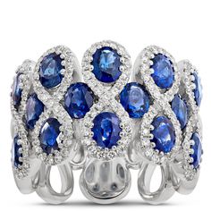 This stunner of a gemstone ring features 14 sapphires surrounded by figure-eight halos of sparkling round diamonds.  The 14k white gold setting is the perfect pairing of precious metal and gemstones because it elegantly complements the deep blue color of the sapphires and light-catching glow of round-cut diamonds. This is truly an heirloom quality piece made to wear and love for a lifetime Blue Diamond Jewelry, Deep Blue Color, Sapphire And Diamond Ring, Diamond Fashion Rings, Precious Metal, Ring Size Guide, Diamond Fashion, Blue Diamond, Round Cut Diamond