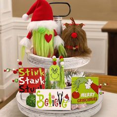 there are two stuffed animals in the basket on the table and one is wearing santa's hat