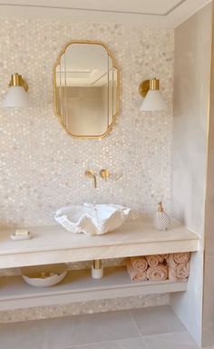 a bathroom with a sink, mirror and towel rack on the wall next to it