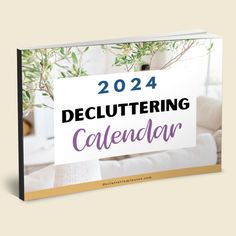 a book with the title, 2021 decluttering calendar written in purple and gold