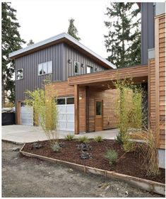 a modern house with wood siding and garage