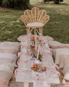 a table set up with pink and white linens