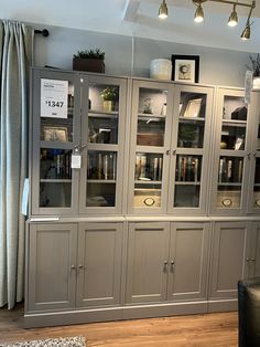 a large bookcase with glass doors in a living room