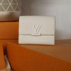 Louis Vuitton's Emblematic Capucines Xs Wallet Is Revisited In A Sophisticated Monochrome Interpretation Which Pairs Finely Grained Taurillon Leather With A Tone-On-Tone Lv Clasp. This Wallet Has A Space-Efficient Design, With A Zipped Coin Pocket, A Flat Pocket And Several Card Slots Contained Within Its Extremely Compact Format. Original Dustbag And Box With Purchase. Luxury White Wallets For Everyday Use, Luxury White Wallet For Travel, Luxury White Travel Wallet, Designer White Travel Wallet, Luxury White Wallet, Lv Capucines, Space Efficient, Louis Vuitton Bags, Vuitton Handbags