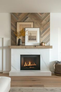 a living room with a fire place and pictures on the wall above it's mantle