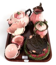 an assortment of vases and dishes on a tray