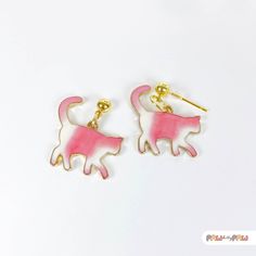 Add a touch of whimsy to your outfit with these adorable Pink Cat Enamel Earrings! Perfect for cat lovers and kawaii enthusiasts alike, these dainty accessories capture the essence of cute and quirky fashion.  🌸✨ Specification ✨🌸 * 18k Gold Plated Earrings * Enamel Charm Size is approx. 2.5 x 2.5 cm Handmade with love, each earring features an irresistibly charming pink cat that's sure to make a statement and bring joy wherever you go. Whether you're looking for a unique gift or a fun addition White Cat Design Earrings For Gift, White Cat Design Earrings As A Gift, White Cat Design Earrings As Gift, Cute White Cat Ears Jewelry, Pink Cat Design Earrings With Cat Ears Shape, Cute Cat Ears Earrings With Cat Print, Pink Cat Ears Jewelry As Gift, Pink Cat Ears Jewelry As A Gift, Pink Cat Design Jewelry With Cat Ears