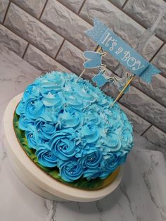 a cake with blue frosting and decorations on top