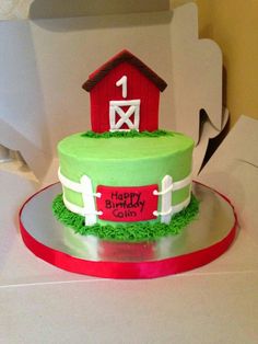 a birthday cake decorated with grass and a farm scene