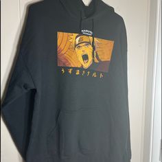 Naruto Sweatshirt Is Hooded Pullover With Drawstrings.Naruto Graphic On Front With Japanese Lettering Down Sleeves Only Tried On Never Worn!Size Large Casual Hooded Top With Anime Print, Casual Anime Print Hooded Top, Casual Anime Print Hoodie Sweatshirt, Casual Tops With Drawstring Hood For Fans, Casual Fan Merchandise Hoodie Sweatshirt, Casual Hoodie Sweatshirt For Fan Merchandise, Black Anime Print Hoodie, Orange Casual Hoodie With Graphic Print, Casual Sweatshirt With Drawstring Hood For Fans