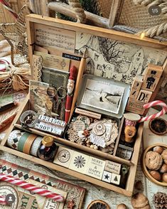 an open wooden box filled with lots of different types of crafting items and decorations