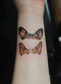 two small foxes tattoo on the wrist