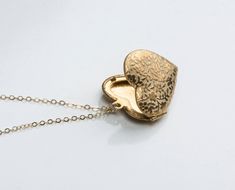 "Super pretty floral heart locket includes tiny vintage raised flowers. Model is wearing a 18\" (shortest in photos), 24\" (mid length rose) and 30\" (long) chain. Available in rose and silver plated as well as solid golden raw brass. D E T A I L S : -Pendant is solid raw brass or silver platd or rose plated -Made from a vintage mold -Chain is 14kt gold fill, sterling silver or 14kt rose fill depending on your choice in the drop down menu -Need more? Just convo us, we may have multiples availabl Vintage Rose Gold Locket Necklace For Gift, Vintage Rose Gold Locket Necklace Gift, Vintage Rose Gold Locket Necklace For Valentine's Day, Vintage Rose Gold Heart Locket Necklace, Elegant Vintage Charm Locket Necklace For Valentine's Day, Elegant Heart Necklace With Vintage Charm As Gift, Heart-shaped Locket Necklace For Wedding, Valentine's Day, Heart-shaped Locket Necklace For Wedding On Valentine's Day, Heart Shaped Locket Necklace For Valentine's Wedding