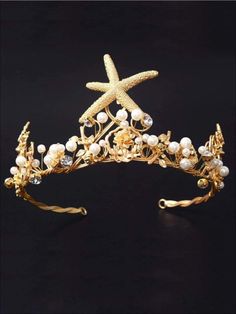 a gold tiara with starfish and pearls