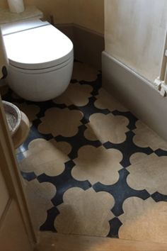 a white toilet sitting next to a bath tub in a bathroom