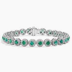 Get lost in the 360-degree sparkle of this 18k white gold bracelet designed with a string of round emeralds surrounded by delicate diamond halos that reflect a delightful display of color and light. Formal White Gold Diamond Bracelet With Emerald, Emerald Diamond Bracelet In White Gold For Formal Events, White Gold Diamond Bracelet With Gemstone, Elegant White Gold Diamond Bracelet With Emerald, White Gold Bracelet With Halo Setting, Green Diamond Bracelets With Brilliant Cut, Green Diamond Bracelet With Brilliant Cut, Luxury Diamond Bracelets With Halo Setting, Luxury Formal Bracelet With Halo Setting