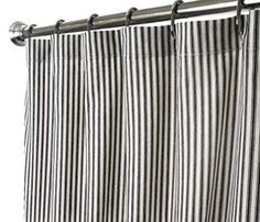 a black and white striped curtain hanging from a metal rod