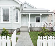 a white picket fence in front of a house