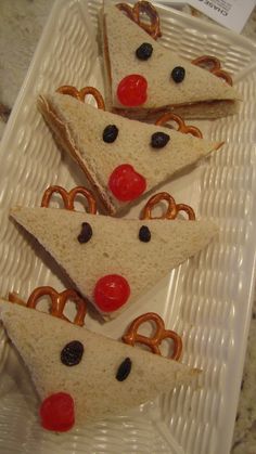 slices of pizza with pretzels and cherries are arranged on a plastic plate