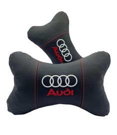 two black and red pillows with audi logos on them