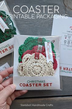 a package of crochet christmas coasters is being held by someone's hand