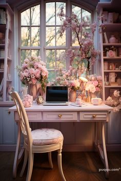 a desk with a laptop on it and flowers in vases next to the window