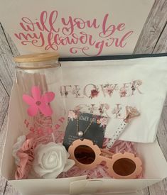 an open box containing sunglasses, flowers and greeting cards with the words will you be my flower girl?