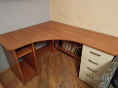 a corner desk with drawers in an office