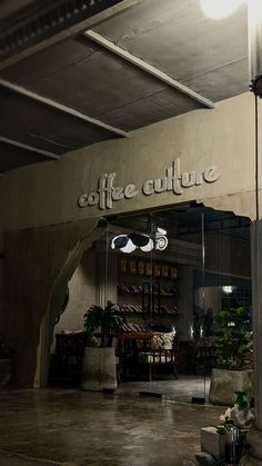 the inside of a coffee shop with lights on and signs above it that read, coffee culture