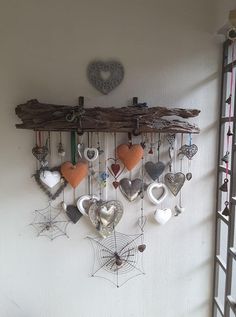 the heart shaped ornaments are hanging on the wall