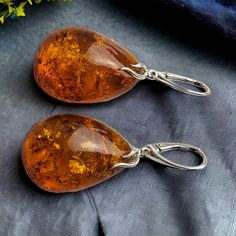 MORE AMBER EARRINGS - https://www.etsy.com/ie/shop/PreciousAmber?ref=hdr_shop_menu§ion_id=19068095 MATCHING PENDANT - https://www.etsy.com/ie/listing/1717330282/natural-large-baltic-amber-drop-pendant?click_key=2c7dbf08b6904ea28db4235df847312735a6cfc0%3A1717330282&click_sum=f6bd4126&ref=shop_home_active_35&pro=1&frs=1 Elevate your style with our stunning large honey Baltic Amber flat-back teardrop earrings. Crafted with care, each earring features a sizable yet lightweight teardrop-shaped Baltic Cheap Amber Dangle Jewelry, Real Honey, Amber Earrings, Luxury Gift Box, Amber Jewelry, Large Earrings, Drop Earring, Silver Accents, Drop Pendant