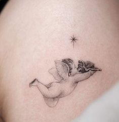 a woman's stomach with a small tattoo of two birds on her belly and the star above it