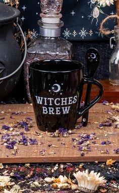 a witches brew mug sitting on top of a wooden table