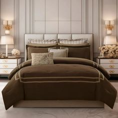 a bed with brown comforter and pillows in a room next to two nightstands