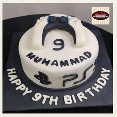 a white and black birthday cake with the number 9 on it