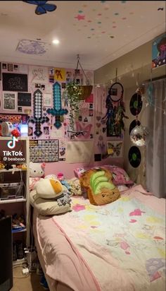 a bed room with a neatly made bed and lots of pictures on the wall