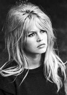 a black and white photo of a woman with long blonde hair wearing a t - shirt