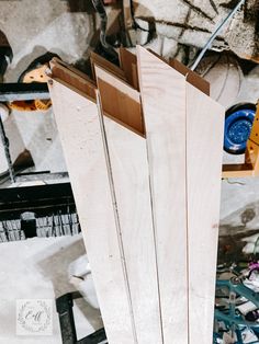 several pieces of wood sitting on top of each other in a room with tools and materials