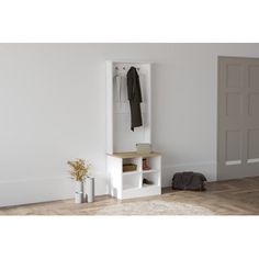 a white coat rack sitting in the corner of a room