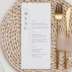 a place setting with goldware and a thank you card on top of the table