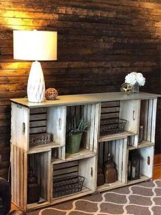 a wooden shelf with crates on it and a lamp in the corner next to it