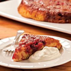 a piece of cake on a plate with whipped cream