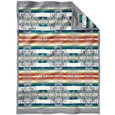 a multicolored blanket on top of a white tablecloth with an orange, green, and blue design