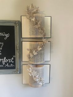 three books are stacked on top of each other in front of a chalkboard sign