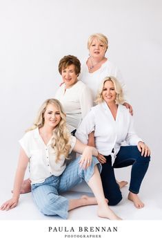 four women are posing for a photo in front of a white background with the words, paula brenan photography