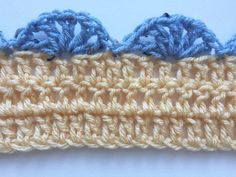 the crochet border is made up of two rows of blue and yellow yarn