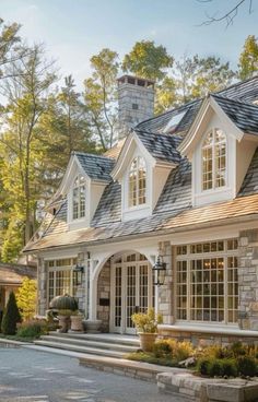 a large stone house with white trim and windows