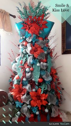 a christmas tree with red, silver and blue decorations