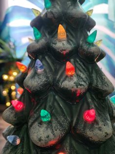 a lit up christmas tree sitting on top of a table